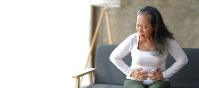 Woman with abdominal pain Getty Images 1830467831