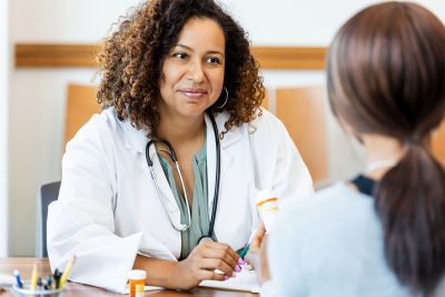 Female physician with female patient Getty Images 2193889757