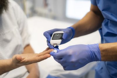 Doctor testing blood glucose Getty Images 2205772477