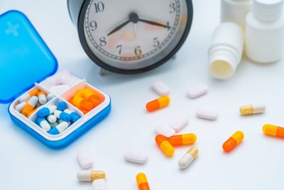 Medications with clock Getty Images 2166582303