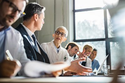 Physician in meeting Getty Images 1488516965