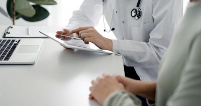 Doctor and patient with tablet Getty Images 1464238865