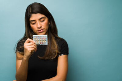 Woman with birth control pills Getty Images 1368423409