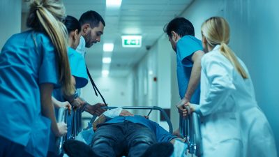 Medical staff with patient on gurney Getty Images 1043634458