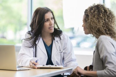 Woman talking with doctor Getty Images 958886670