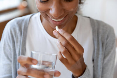 Woman taking pill Getty Images 1313193718