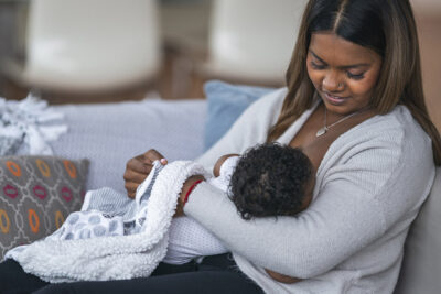 Woman breastfeeding Getty Images 1208244849