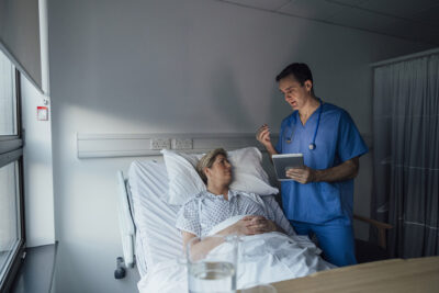 Clinician at patient bedside Getty Images 2132601893