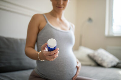 Pregnant woman with medication Getty Images 1443539399