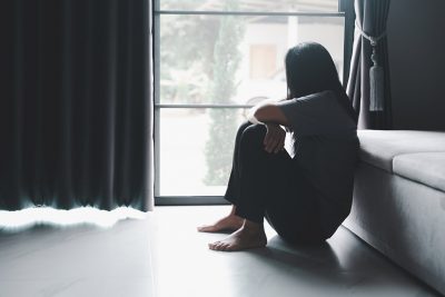 Mental health woman sitting on floor Getty Images 1442432698