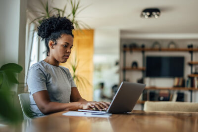 Woman using laptop at home Getty Images 1352469963