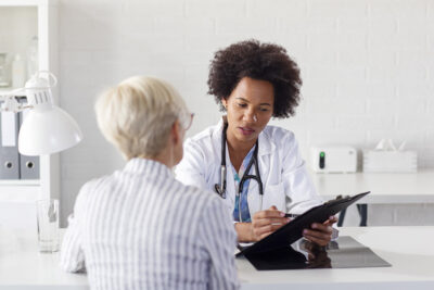 Physician talking to older female patient Getty Images 1175088299