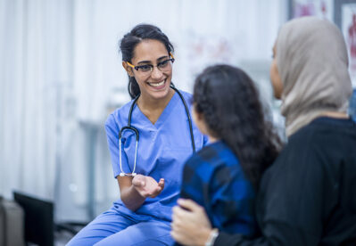 Refugees with healthcare worker Getty Images 1134381003