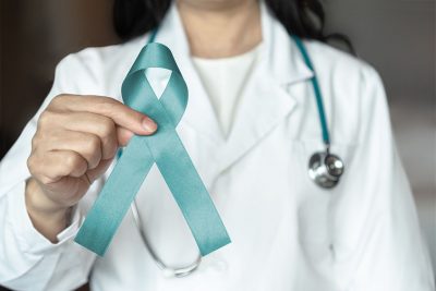 Doctor with cancer awareness ribbon Getty Images 2196105648